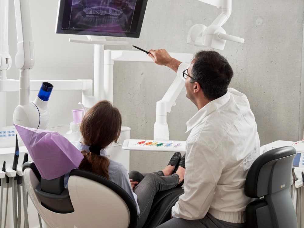 Dentist reviewing digital imaging with a patient